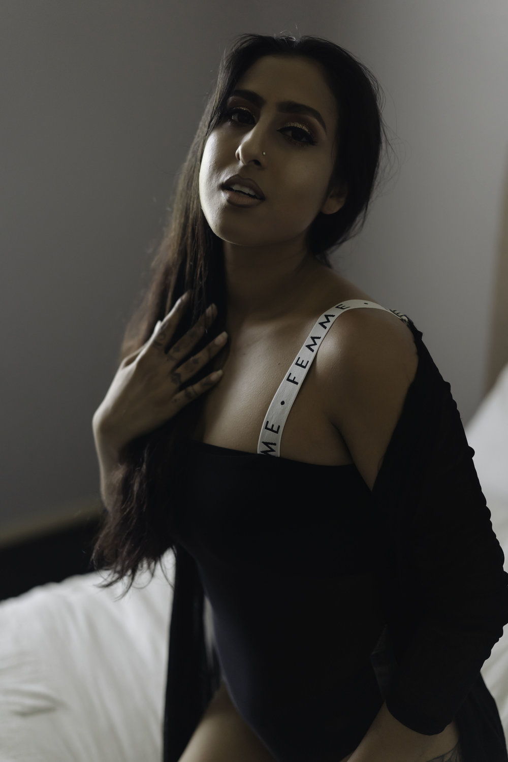 Woman in black shirt, looking camera center. Atlanta boudoir photography.